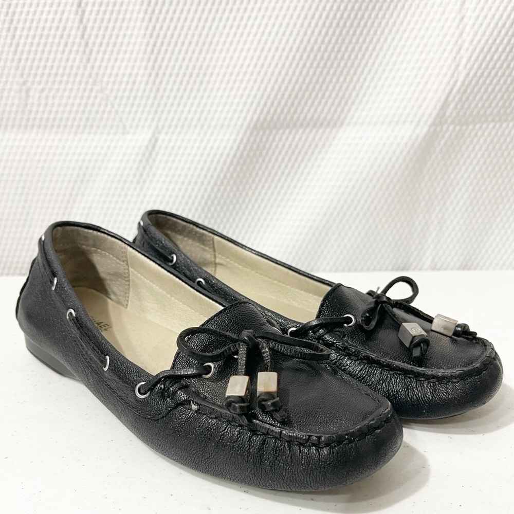 Michael Kors Amber Black pebbled tassel flats.